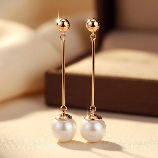 Boucles d'oreilles pendantes longues en or à perle