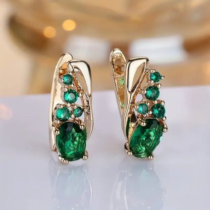 Boucles d'oreilles pendantes cluster en or à émeraude