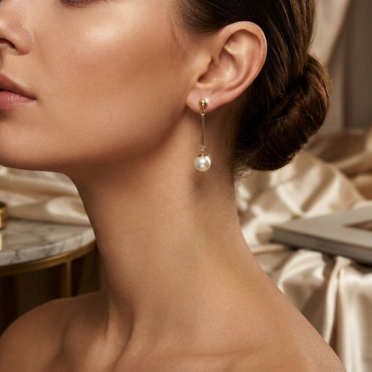 Boucles d'oreilles pendantes longues en or à perle